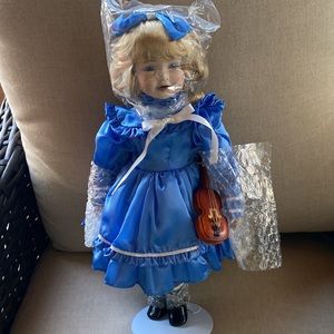 NWOT Porcelain Doll “Ariane” adorned with violin .